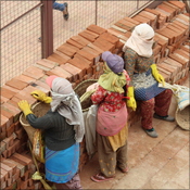 Female labourers take a break from rebuilding Patan